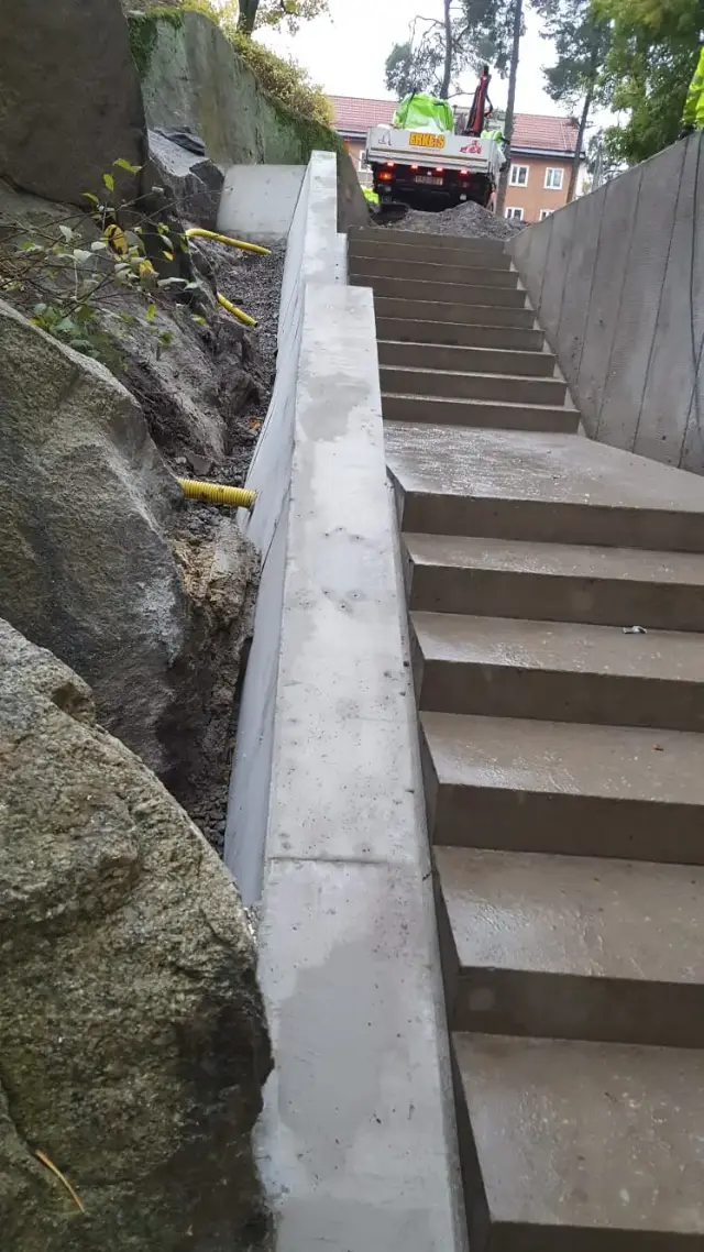 Gjuten betongtrappa längs bergvägg
